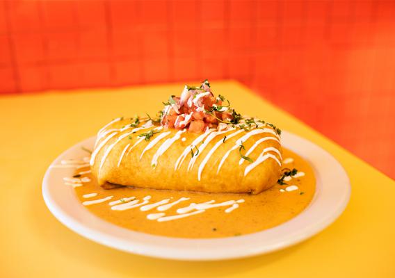 A plate of Chimichangas. Full of Spanish rice, pico de gallo, jack cheese, baja sauce, and your choice of meat or veggie ,topped off with a creamy chipotle sauce.