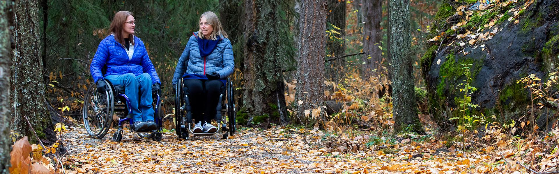 Two women in wheelchairs enjoying Claymine Accessible Trail