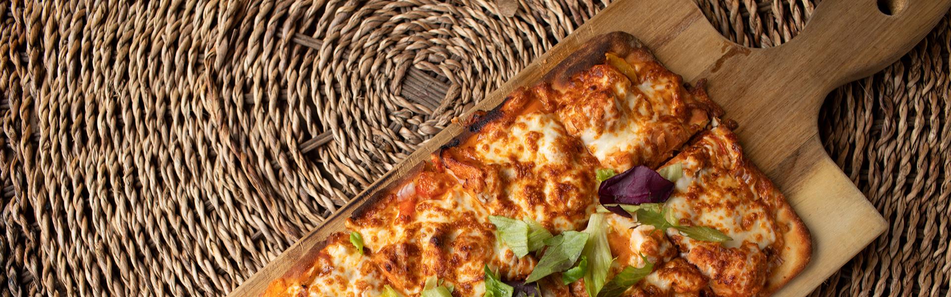 Flatbread pizza served on a charcuterie board