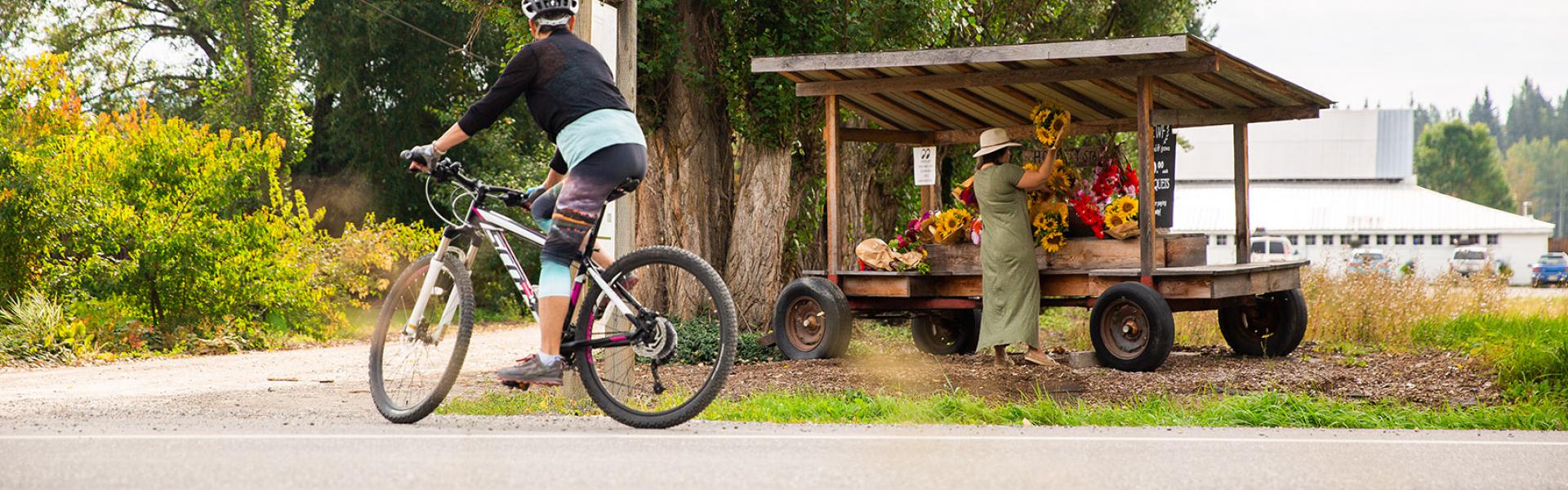 Bike riding past outdoor stand
