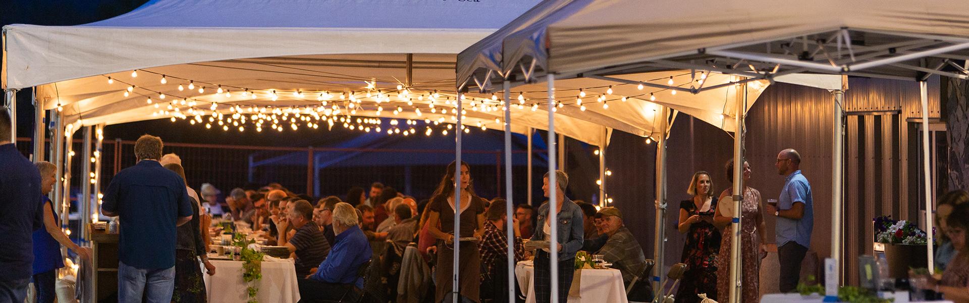 Dinner event under tents and patio lights