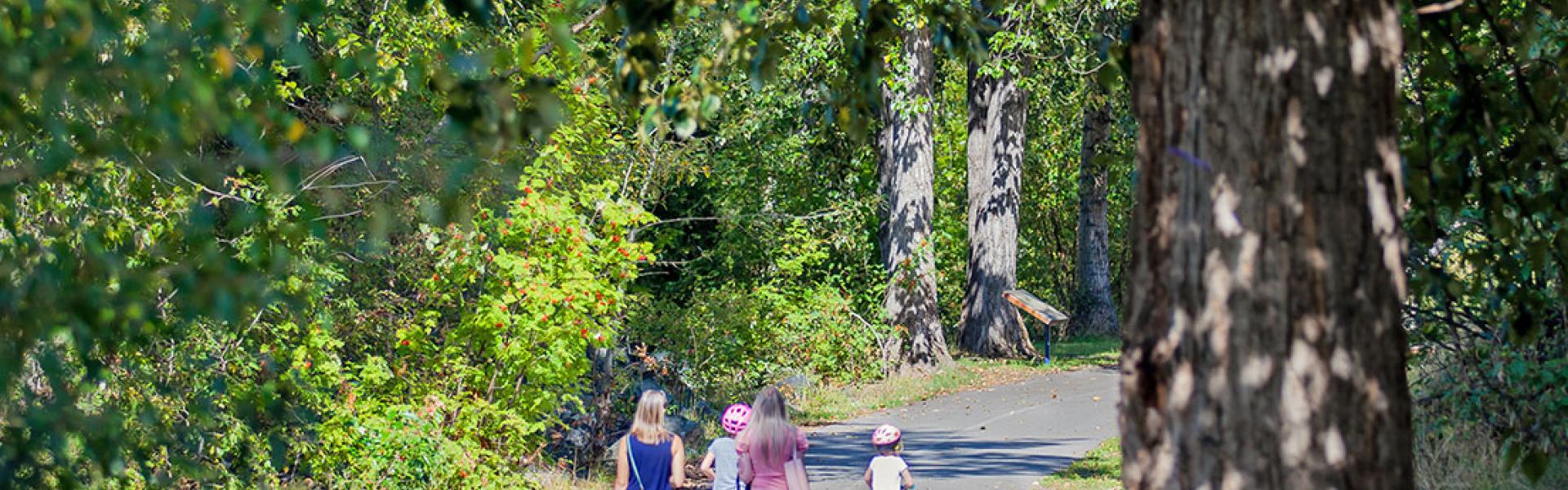 Mothers and daughters walking on paved Riverfront Trail