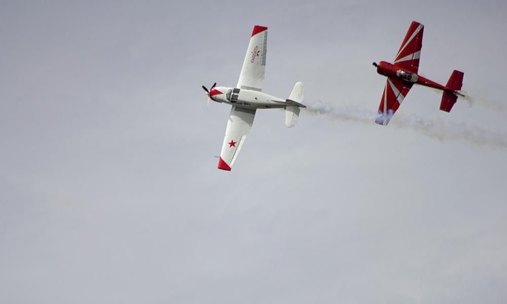 Two airshow planes flying in the sky