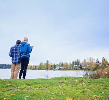 Couple enjoying the view of Dragon Lake in the fall