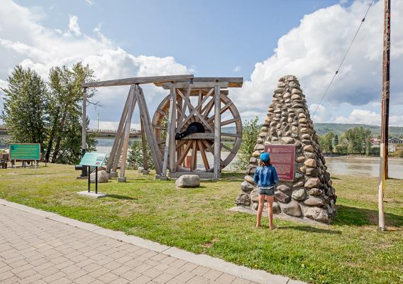 Young girl reading interpretive signage at Heritage Corner in Quesnel